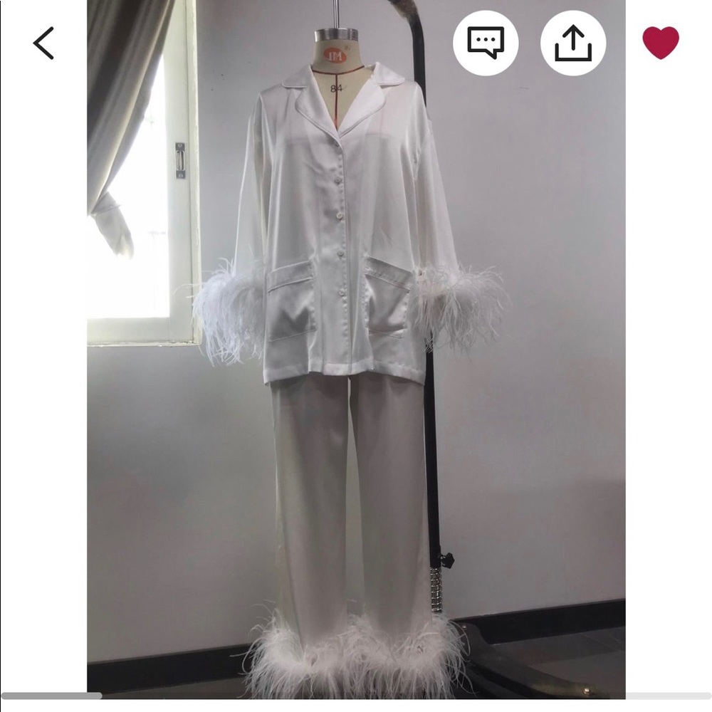 Brand new never worn, white pajama set. Feather details on the arms and pants.